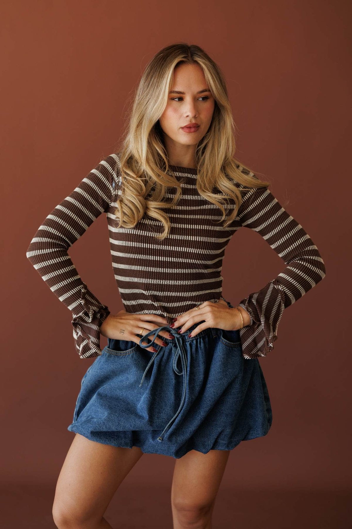 Coffee Stripe Long Sleeve Top, full-length view with a denim skirt