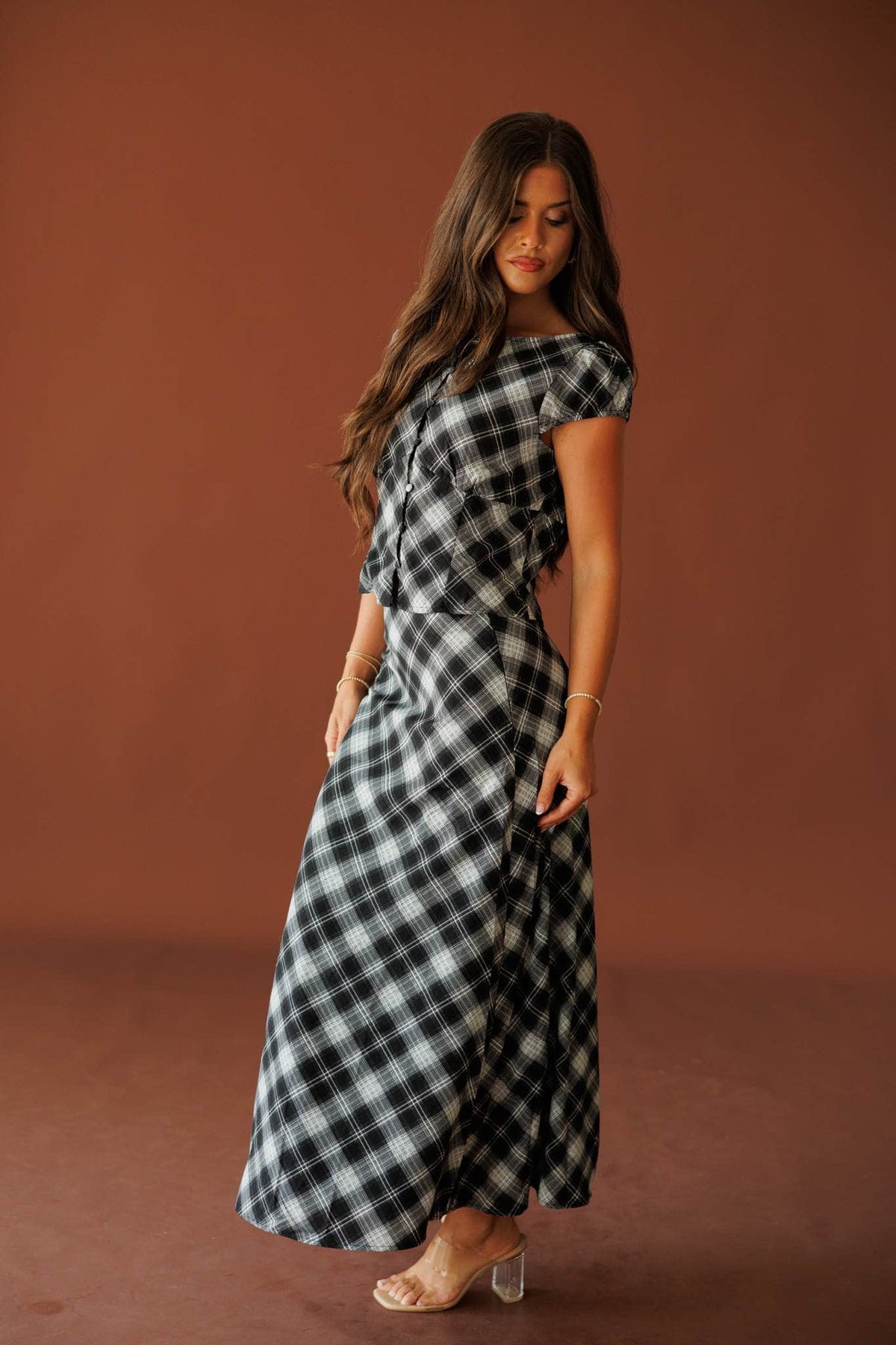 Town Square Plaid Skirt in black, full-length side view on model