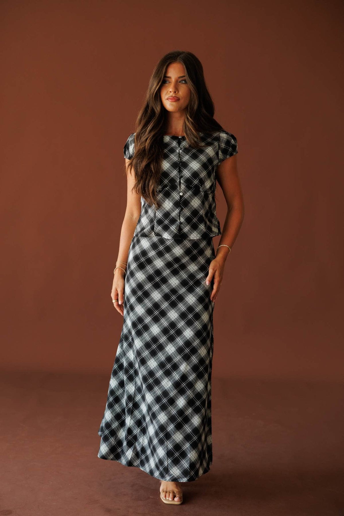 Town Square Plaid Skirt in black, full-length view on model with a matching plaid top