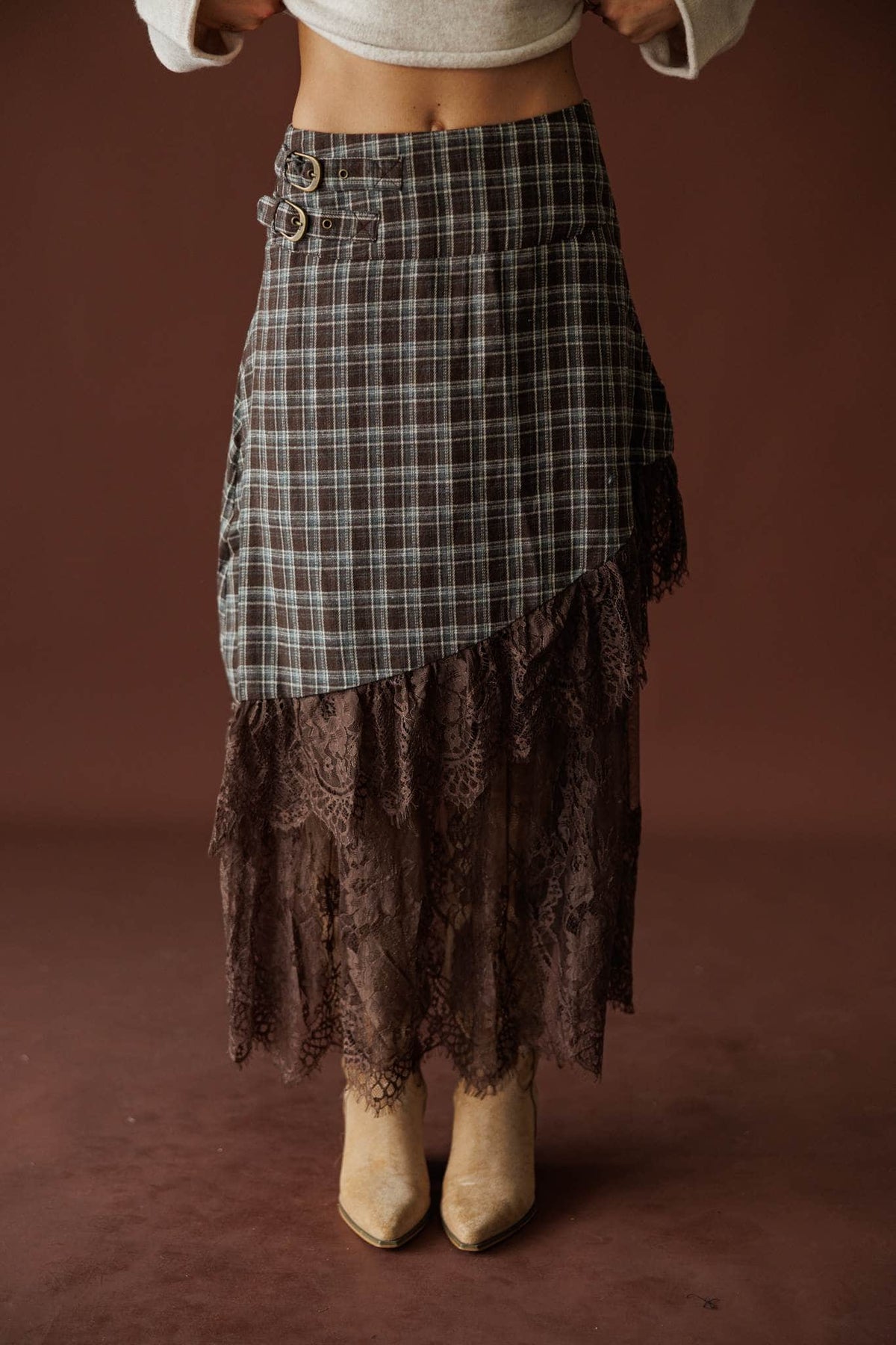 Lost In Wyoming Plaid Skirt in brown, front view of the asymmetric plaid over a lace hem