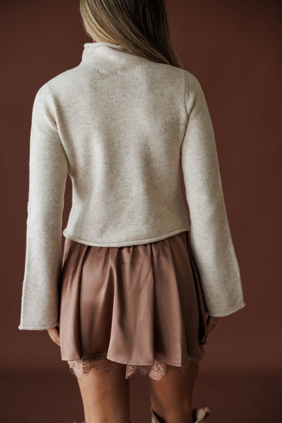 The Cozy Classic Sweater in oatmeal, back view of the cropped boxy fit