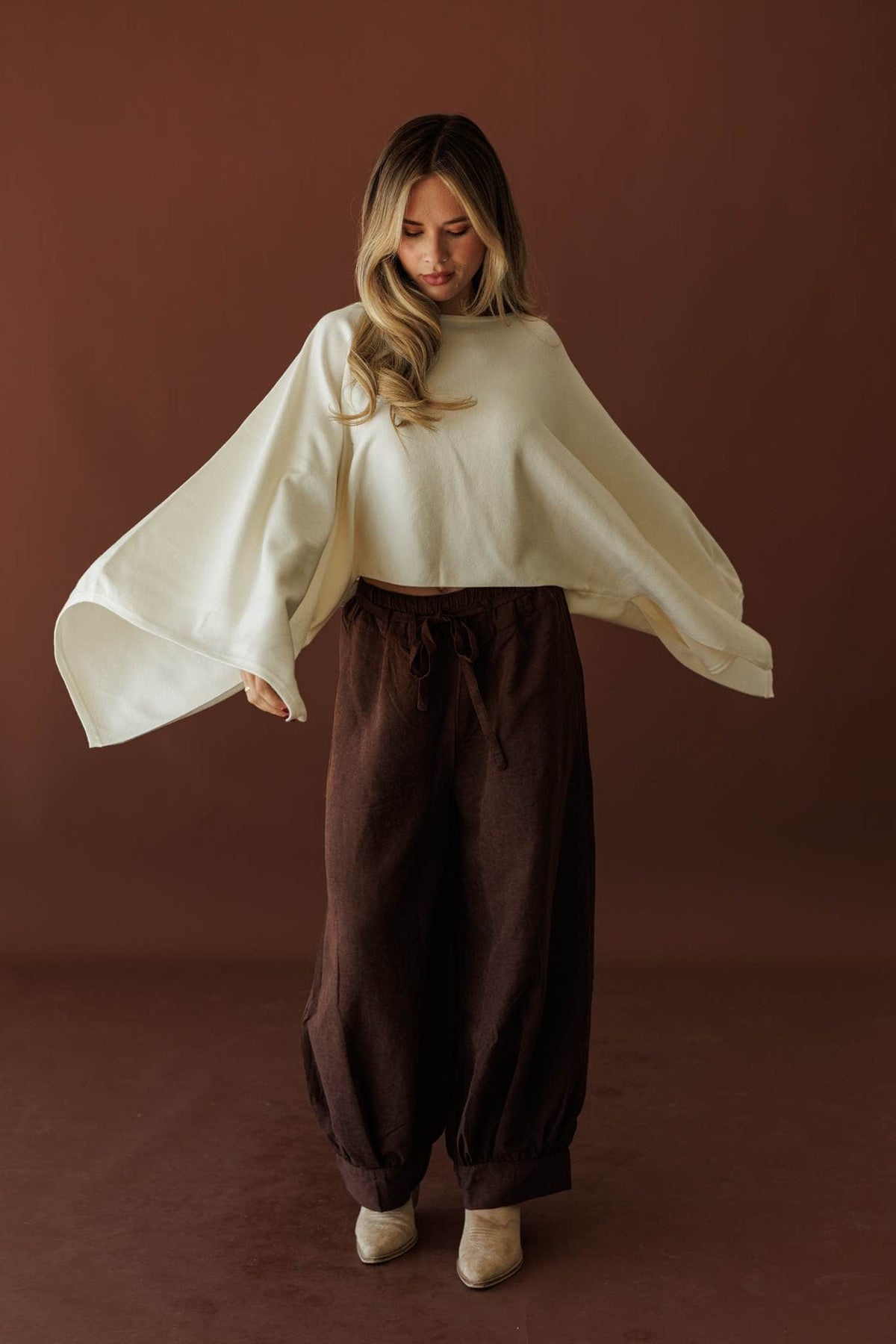 Wide Open Boat Neck Sweater, in cream, full-length view with brown trousers