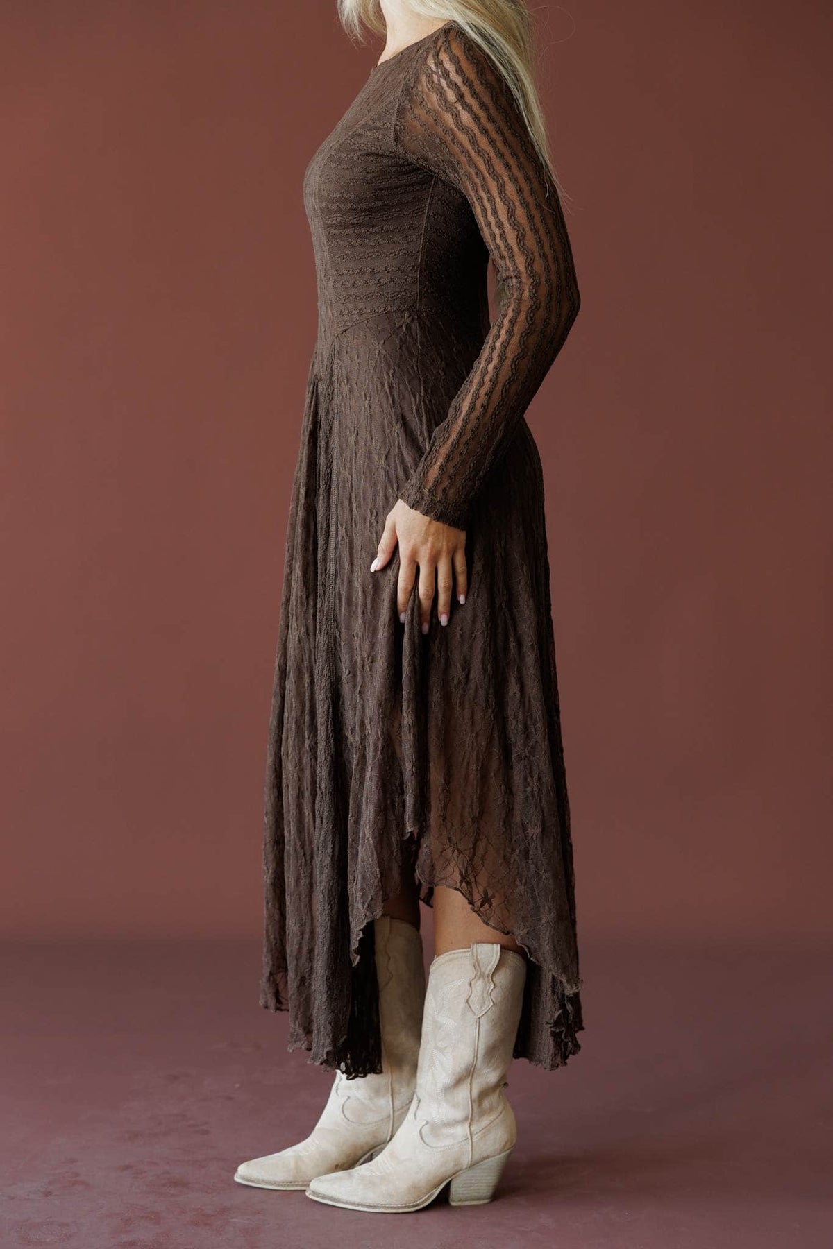 Whiskey And Lace Dress in chocolate, side view showing the asymmetric pleated hem