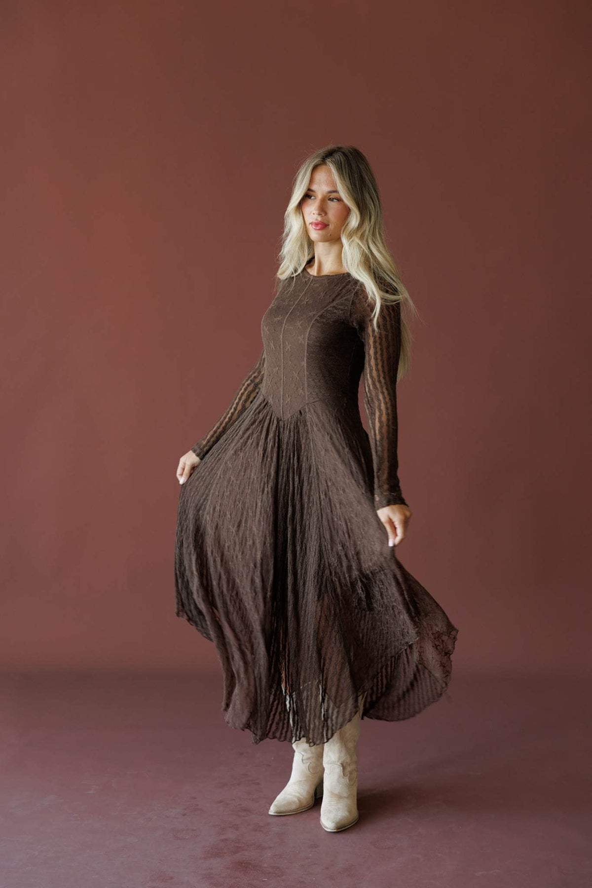 Whiskey And Lace Dress in chocolate, side view showing the pleated skirt in motion