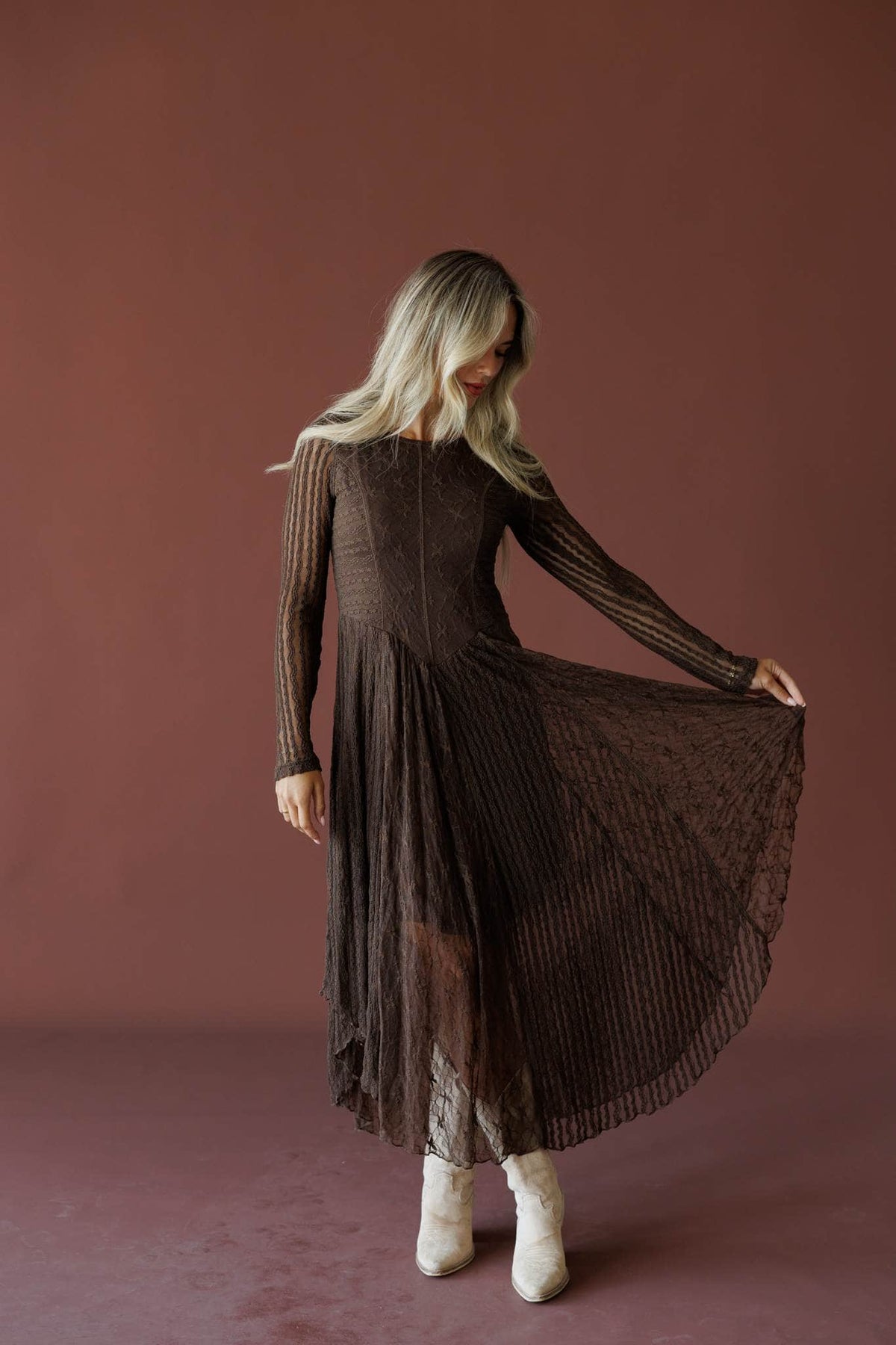 Whiskey And Lace Dress in chocolate, full-length view on model holding the skirt out